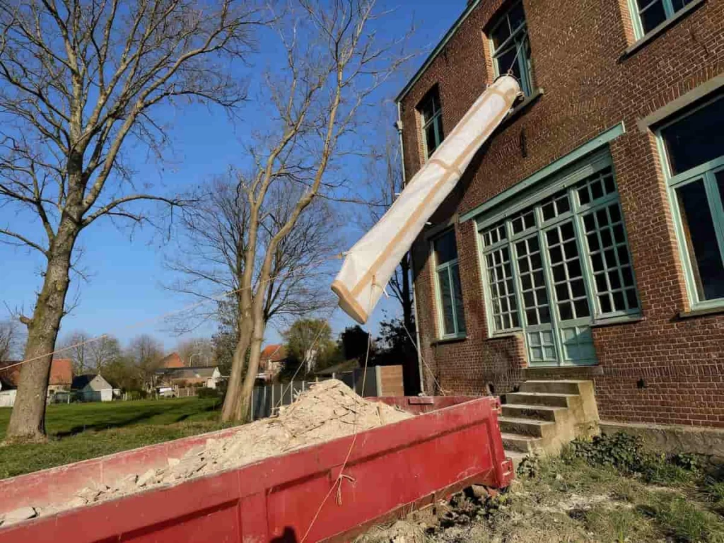 Open end of the PP rubble chute set over the skip, so the load lands inside the container