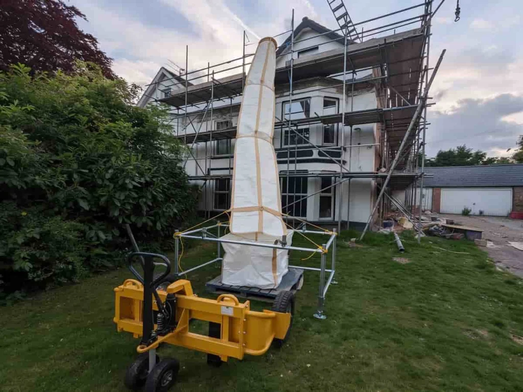 PP rubble chute tied off at its top and hanging free, with the open end above the skip