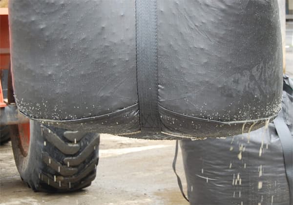 Geotextile dewatering bag filtering sludge on a project site