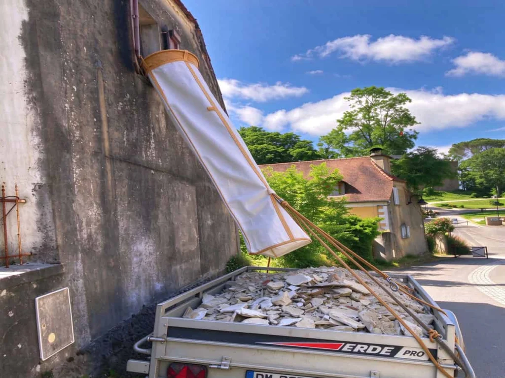 PP Chute The open bottom of the chute tied off by a rope to the trailer, holding the end over the load